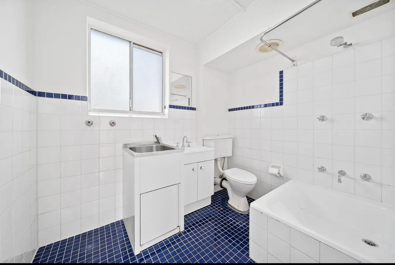 Dated tiled bathroom before renovation