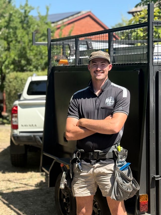 The owner of Willow Carpentry & Construction on site beside the work ute